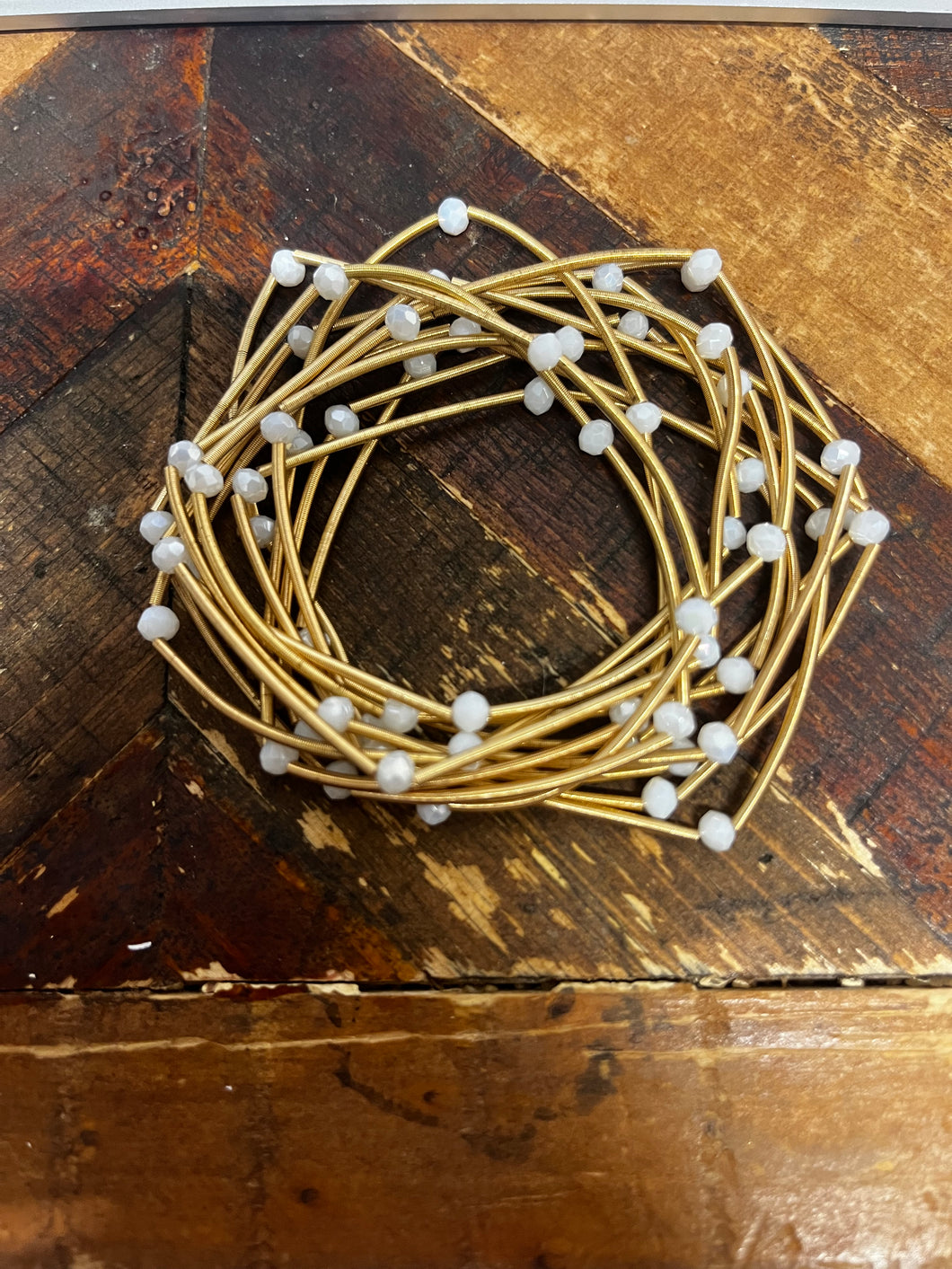 Metal Coil Bracelet Stack With White Beads